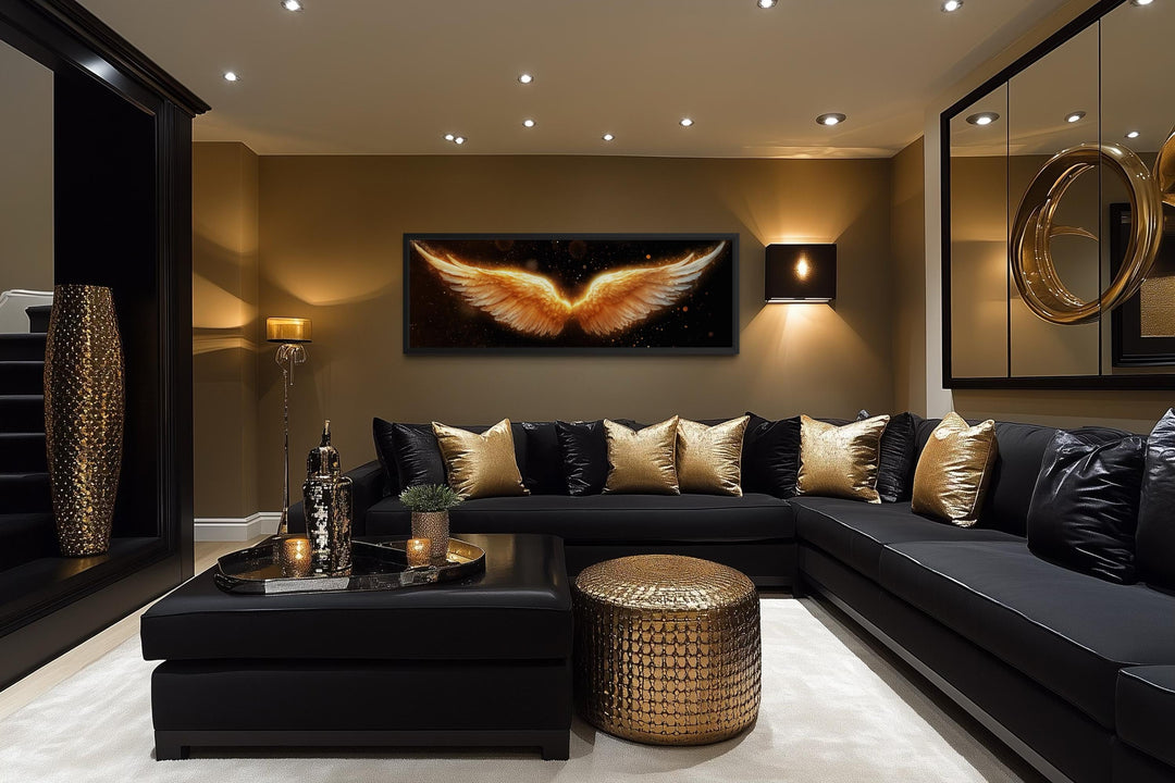 Horizontal canvas print of glowing golden angel wings on a black background in a luxury room.