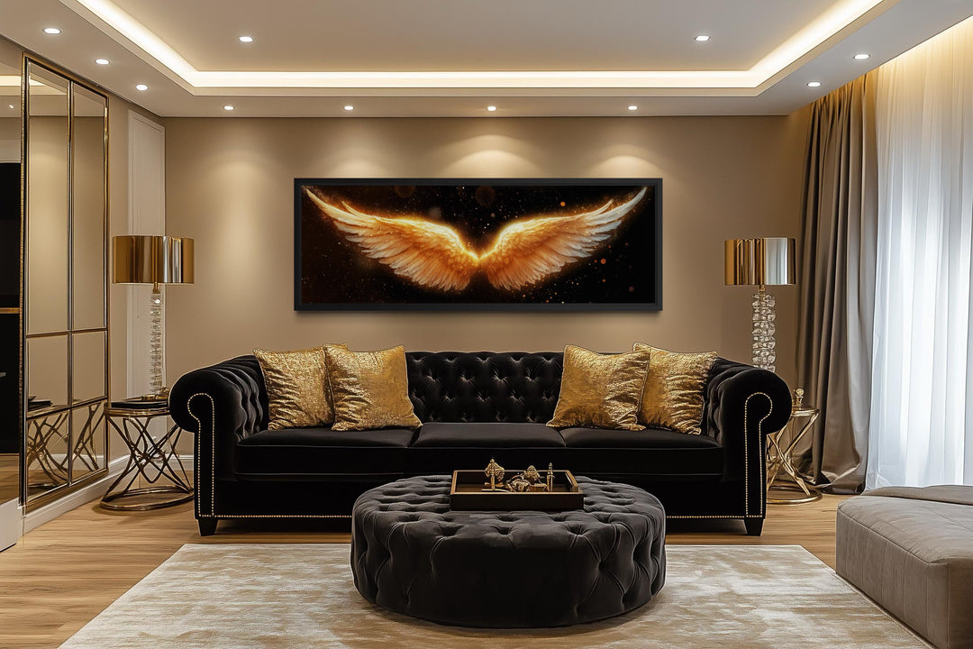 Horizontal canvas print of glowing golden angel wings on a black background in a luxury living room.