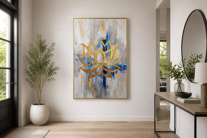 Golden lotus flower outline on abstract blue, gray, and gold background wall art in a modern room.