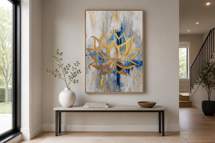 Golden lotus flower outline on abstract blue, gray, and gold background canvas wall art.