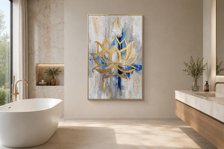 Golden lotus flower outline on abstract blue, gray, and gold background wall art in a bathroom.