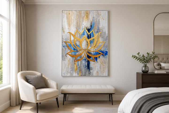 Golden lotus flower outline on abstract blue, gray, and gold background wall art in a bedroom.
