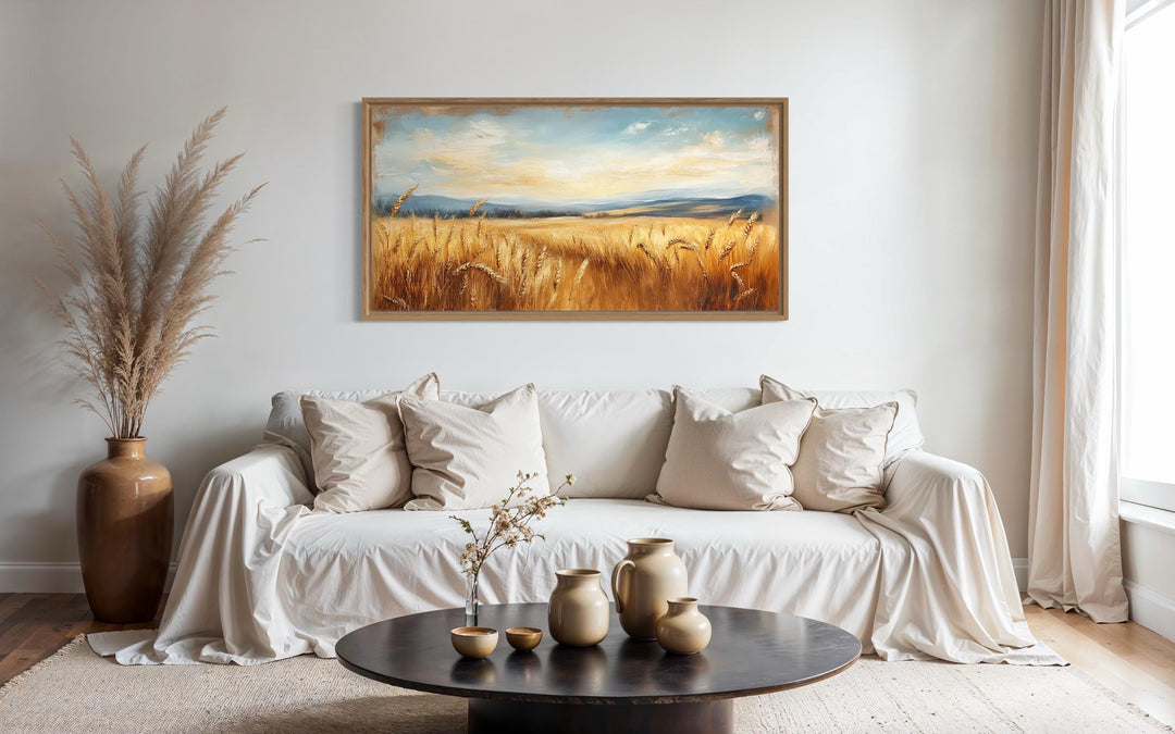 Golden Wheat Field Farm Framed Farmhouse Canvas Wall Art hanging above a neutral sofa.
