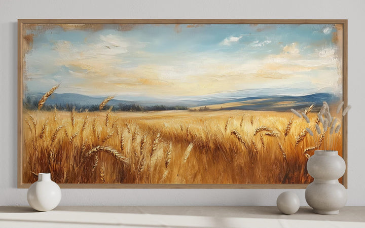 Golden Wheat Field Farm Framed Farmhouse Canvas Wall Art in a wooden frame above a console table.