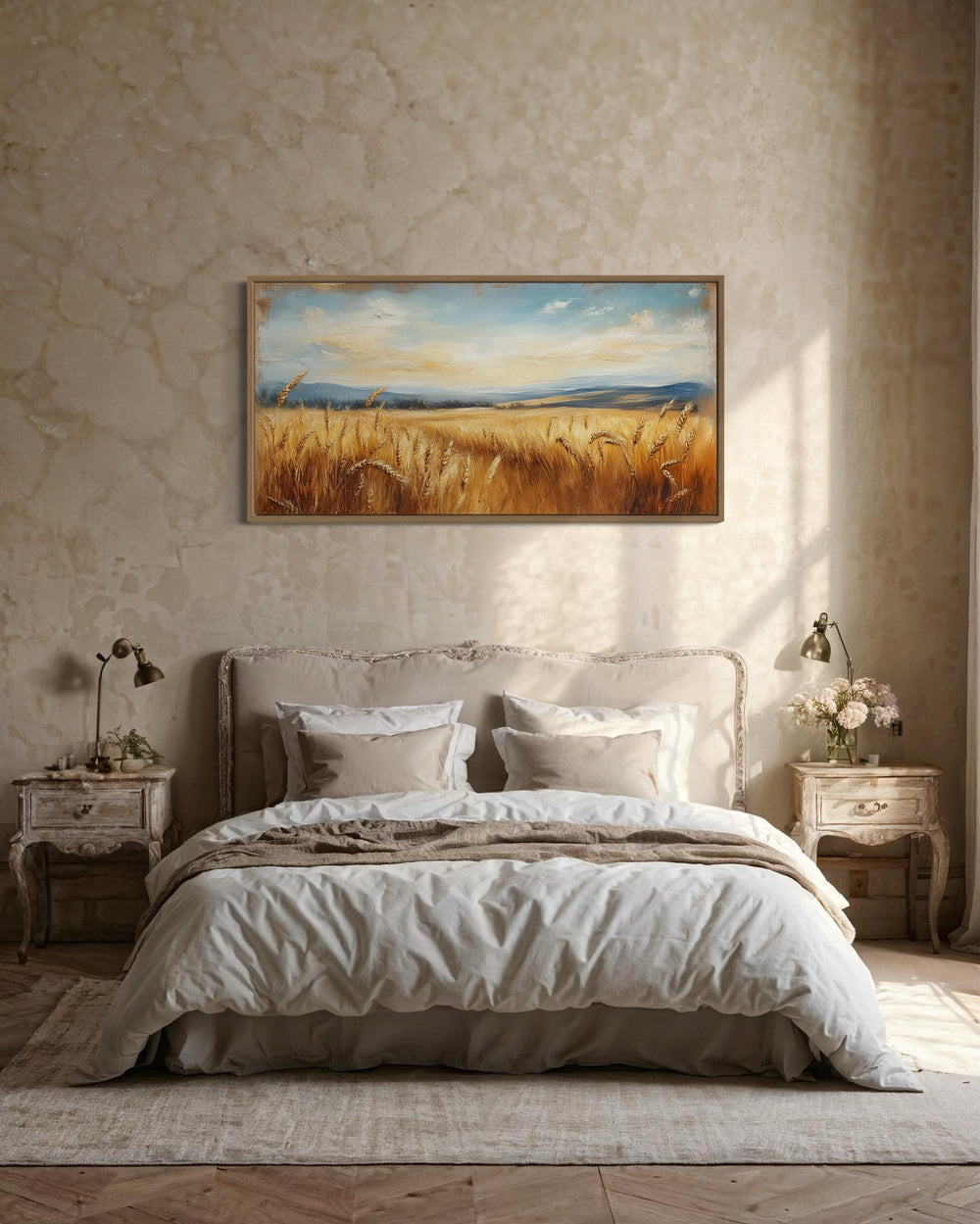 Golden wheat field farmhouse canvas wall art in a wood frame hanging above a bed in a rustic room.