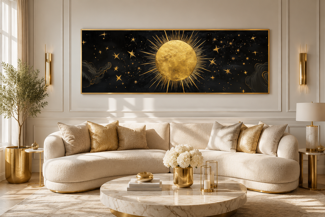 Golden sun and stars black gold long horizontal canvas wall art above a cream sofa.