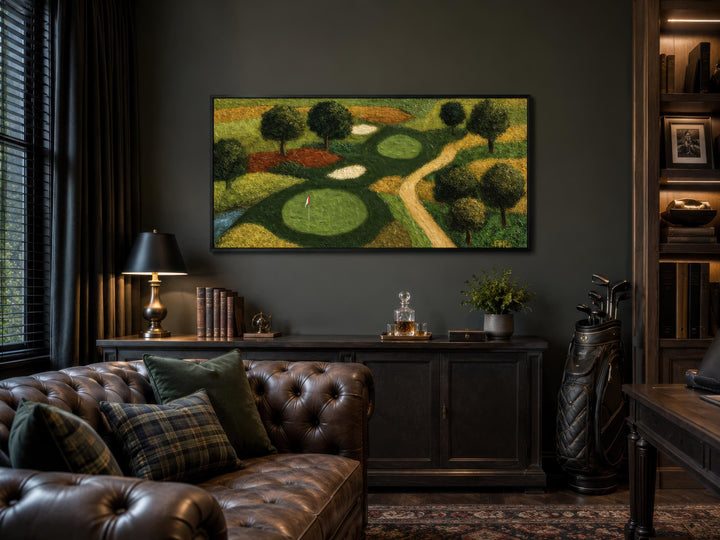Aerial view golf course canvas wall art in a dark-toned home office above a leather sofa.