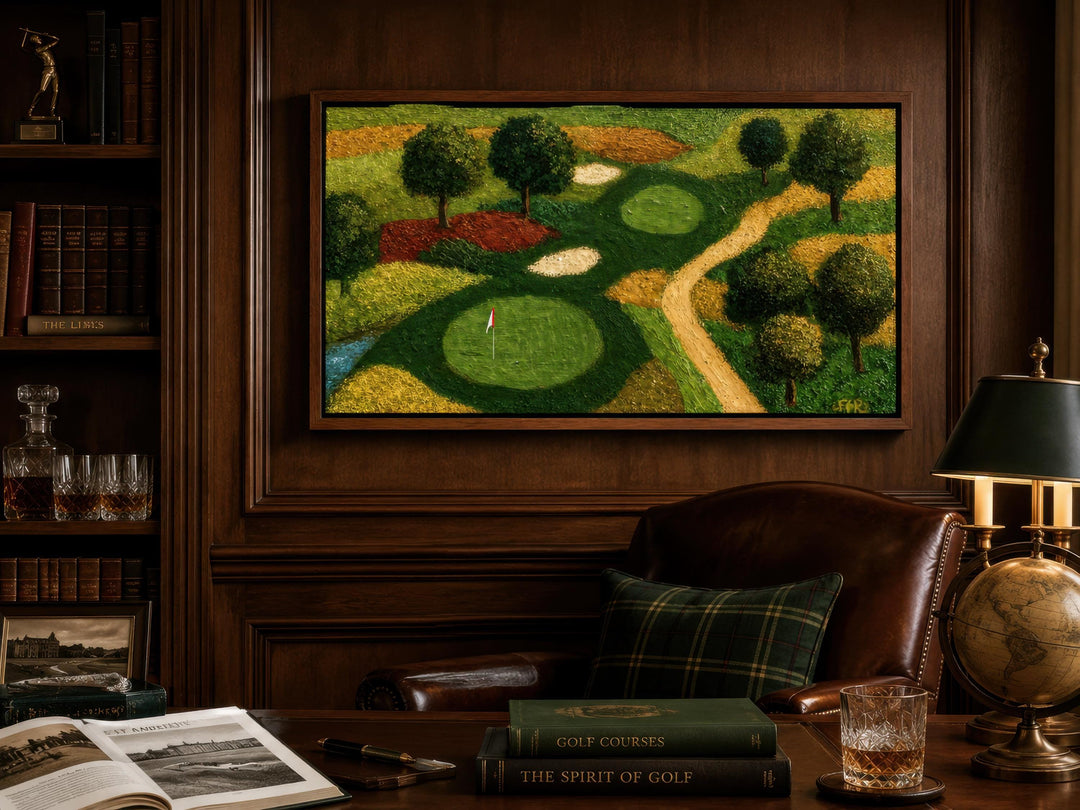 Aerial view golf course canvas wall art in a dark wood-paneled study with leather chair and books.