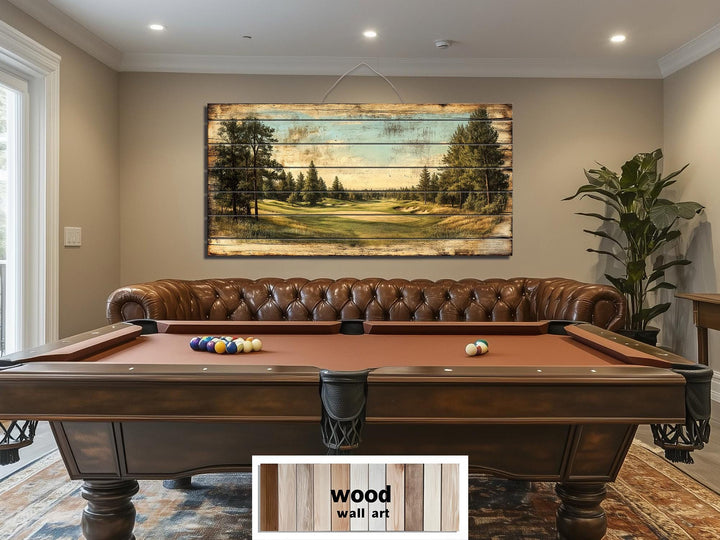 A panoramic golf course scene printed on distressed wood planks hangs above a leather sofa.