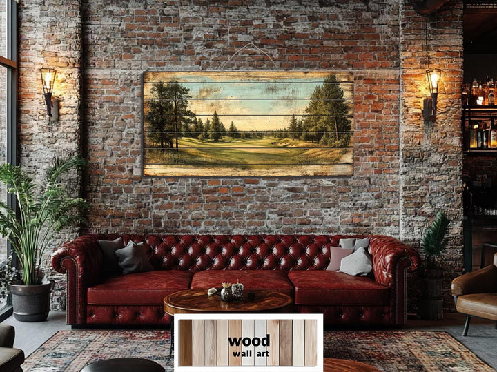 A panoramic golf course landscape printed on distressed wood planks hangs above a leather sofa.