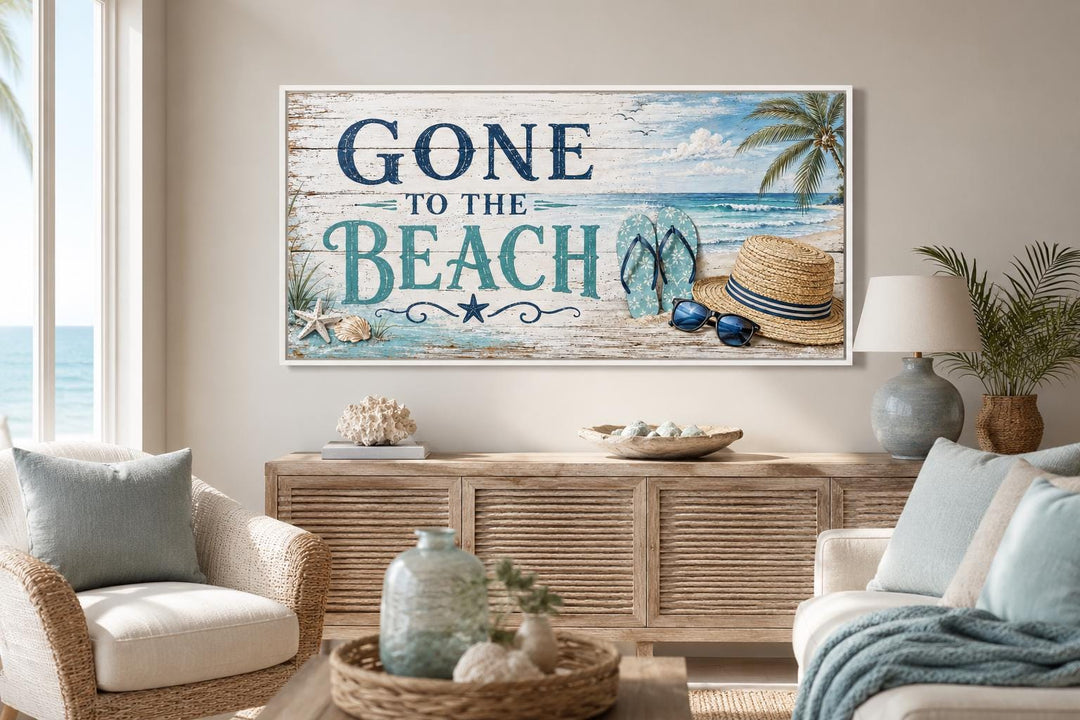 Gone To The Beach horizontal canvas print with blue lettering and beach icons over a wooden console.