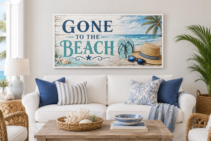 Gone To The Beach Sign horizontal canvas print hanging above a white sofa with coastal decor.