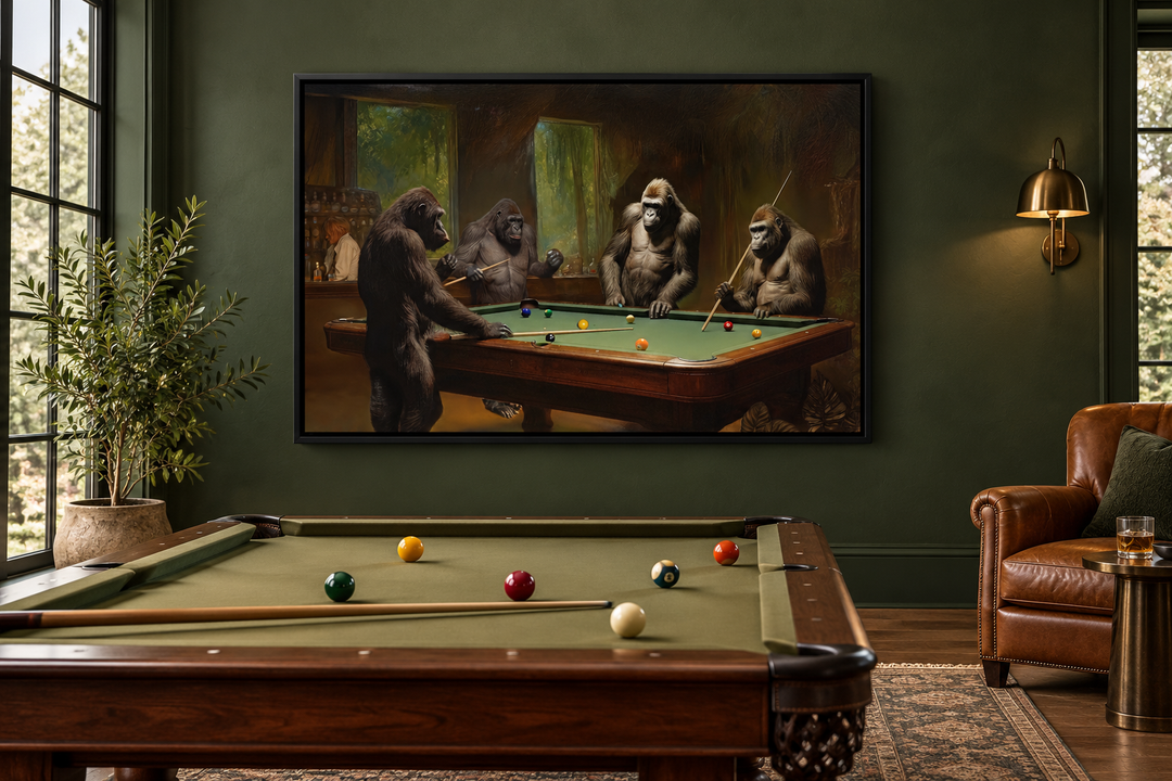 Framed canvas wall art of gorillas playing billiards in a dark green pool room with a leather chair.