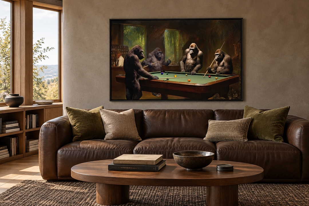 Framed canvas wall art of gorillas playing billiards hanging above a brown leather sofa.