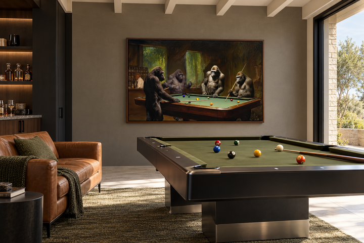 Gorillas playing billiards framed canvas wall art in a modern pool room with a leather sofa.