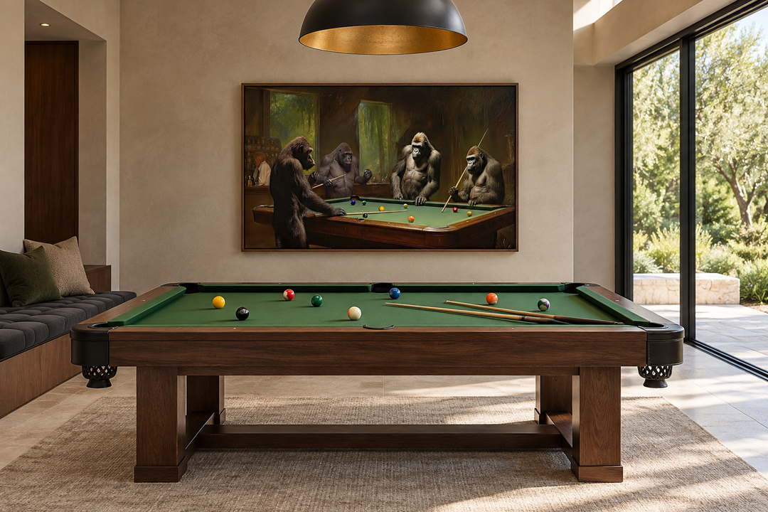 Framed canvas wall art of gorillas playing billiards in a modern game room above a pool table.