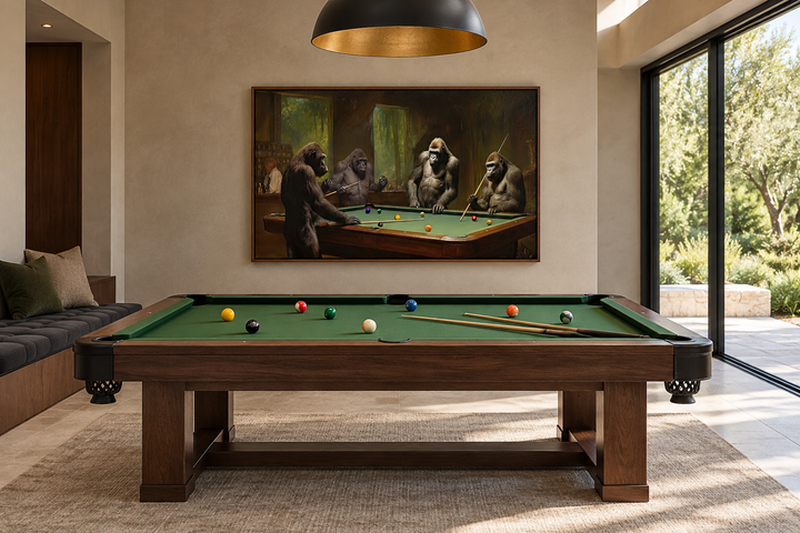 Framed canvas wall art of gorillas playing billiards in a modern game room above a pool table.