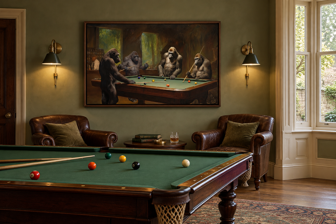 Framed canvas art of gorillas playing billiards hanging in a classic pool room with leather chairs.