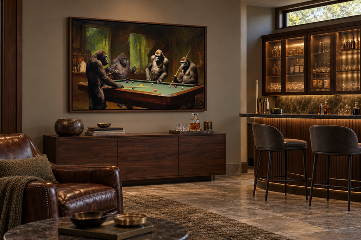 Gorillas playing billiards framed canvas wall art in a walnut frame above a dark wood sideboard.