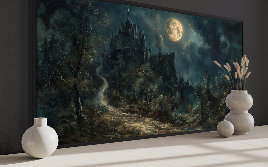 Framed canvas of a dark gothic castle under a full moon with twisted trees and a misty path.