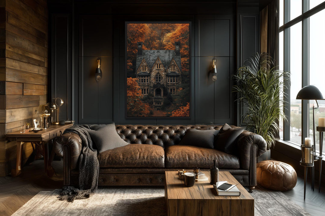 Gothic haunted house canvas art in a dark academia living room with a brown leather sofa.