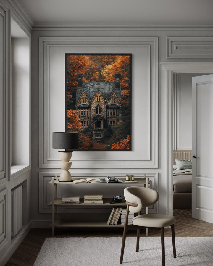 Gothic haunted house canvas art in a black frame above a console table in a dark academia room.