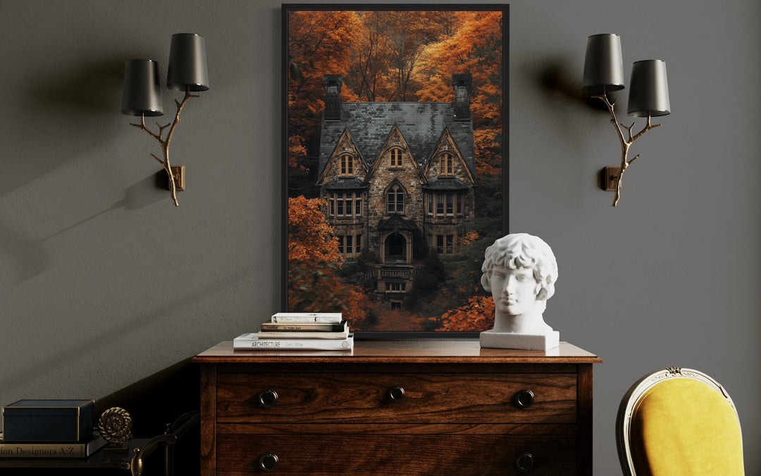 Gothic haunted house canvas art in a black frame above a wooden dresser in a dark academia room.