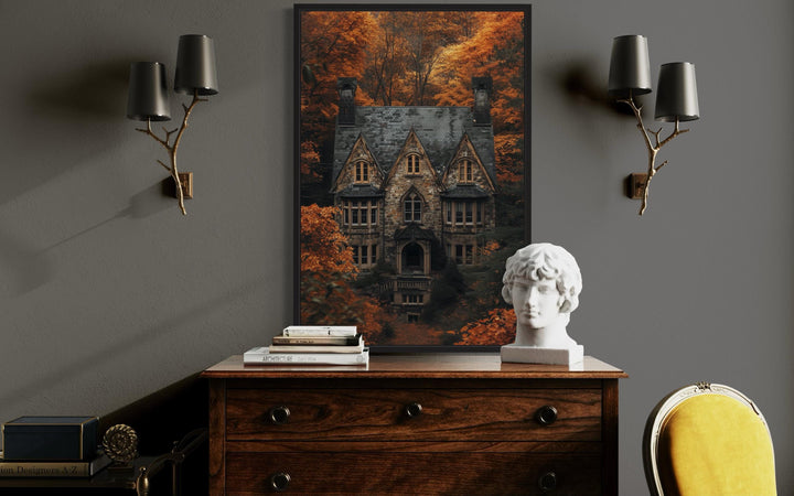 Gothic haunted house canvas art in a black frame above a wooden dresser in a dark academia room.