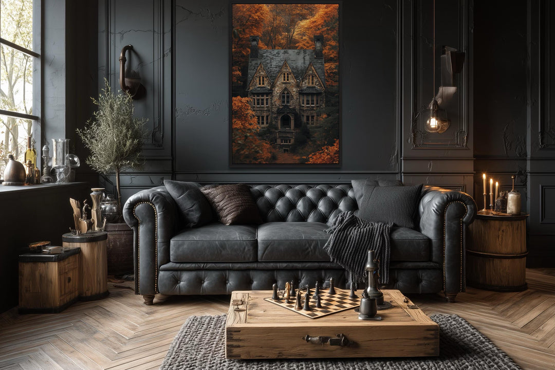 Gothic haunted house canvas art in a dark academia living room above a black leather sofa.