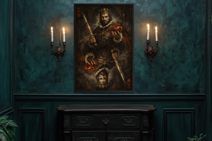 Gothic King of Hearts canvas print in a dark frame on a teal wall between two candle sconces.