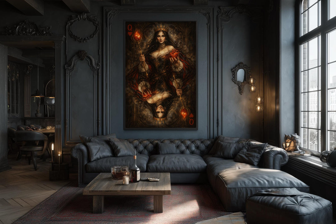 A gothic Queen of Hearts canvas print hangs in a dark, moody living room with a black leather sofa.