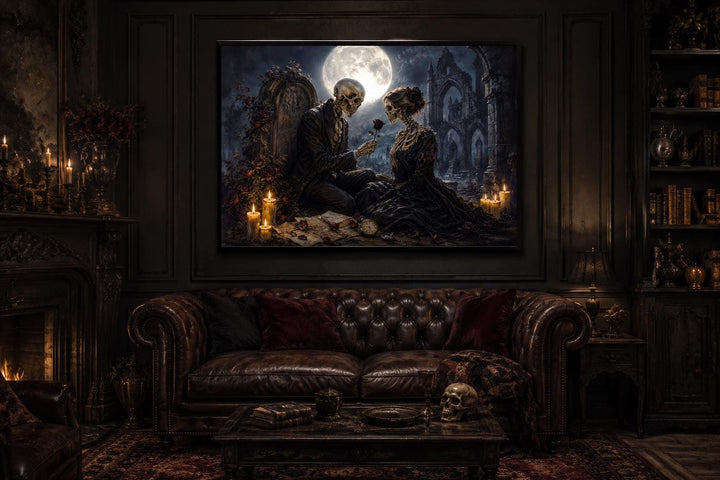 Gothic skeleton couple canvas art above a leather sofa in a dark academia style room.