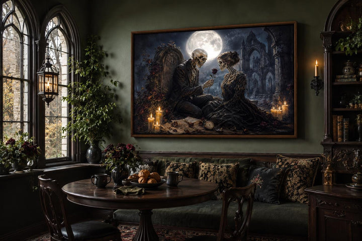 Gothic skeleton couple canvas art in a dark academia room with candlelight and a full moon.