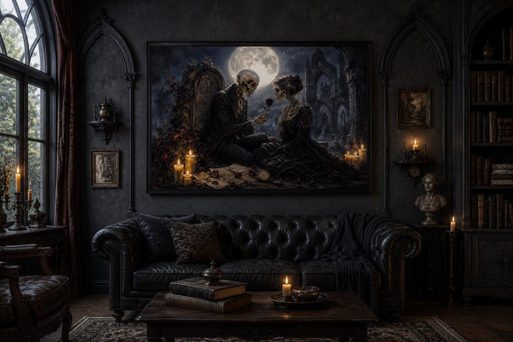 Gothic skeleton couple art canvas hanging above a black leather sofa in a dark academia room.