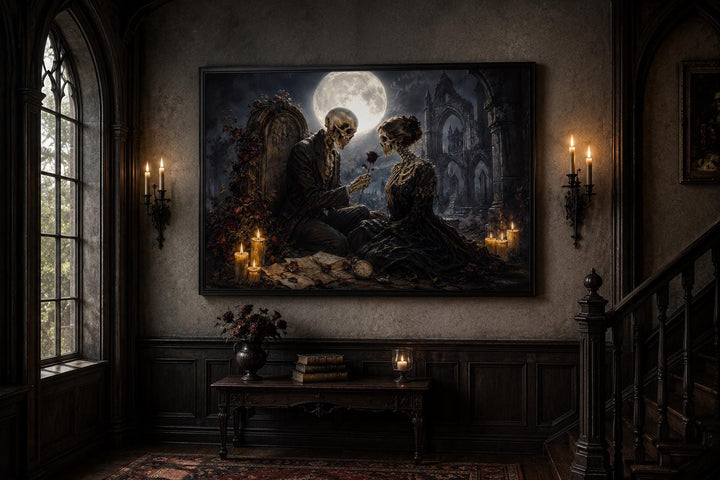 Gothic skeleton couple canvas art in a dark academia room with candlelight and a full moon.
