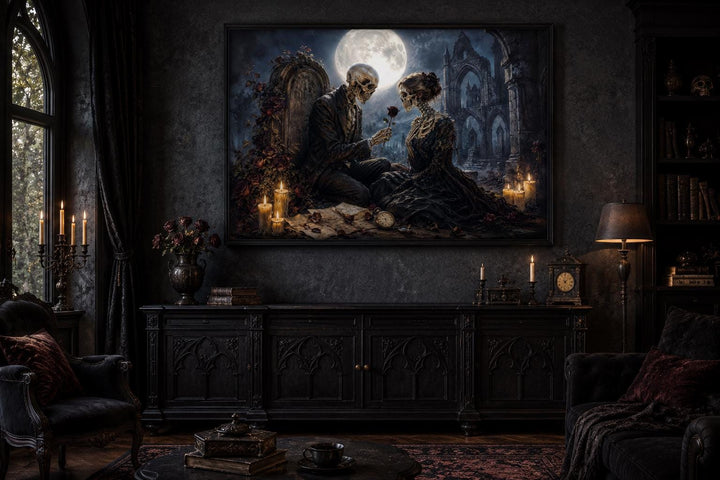 Gothic skeleton couple art canvas hanging in a dark academia room with vintage furniture.