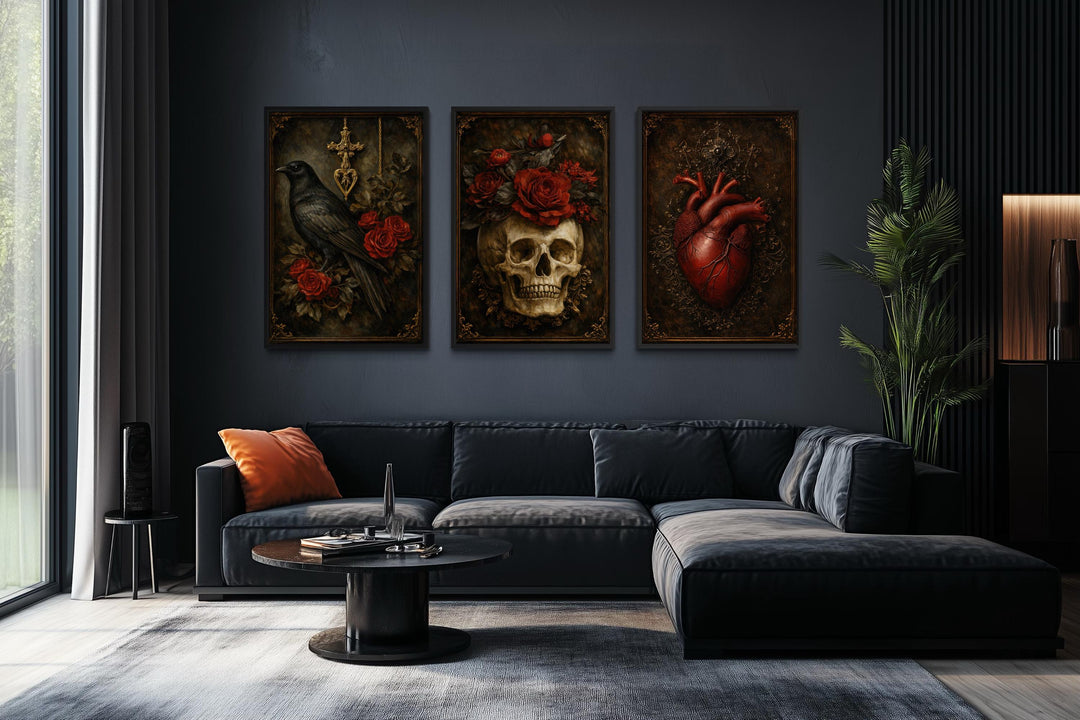 Gothic wall art triptych featuring a raven, skull with roses, and an anatomical heart on a dark wall.