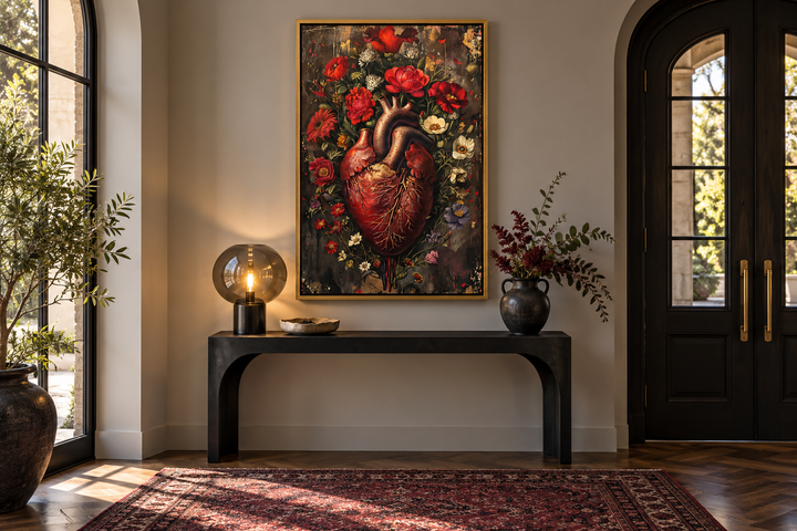 Gothic framed wall art of a human heart entwined with red and white flowers above a black console.