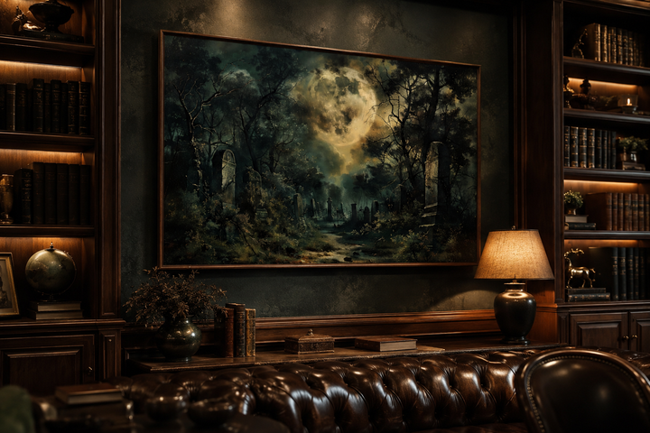 Framed canvas wall art of a haunted cemetery under a full moon in a dark, moody library setting.
