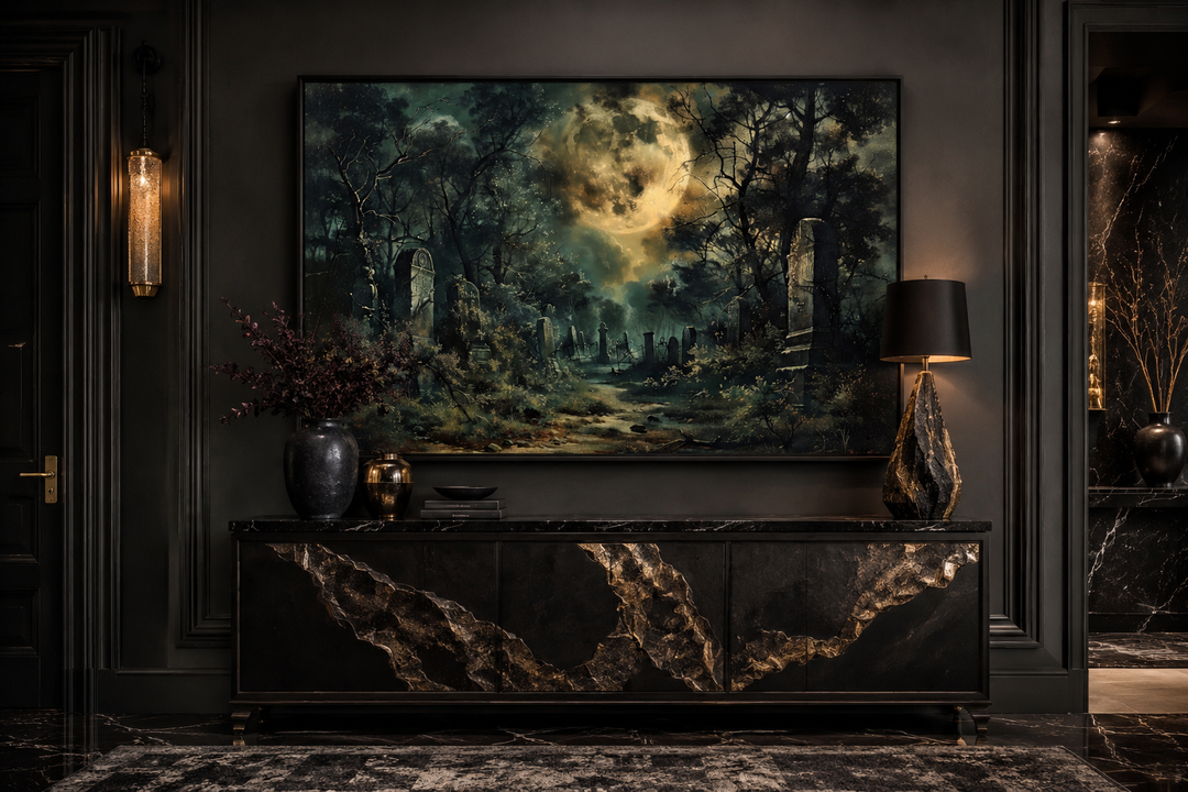Framed canvas wall art of a haunted cemetery under a large full moon in a dark, gothic room.