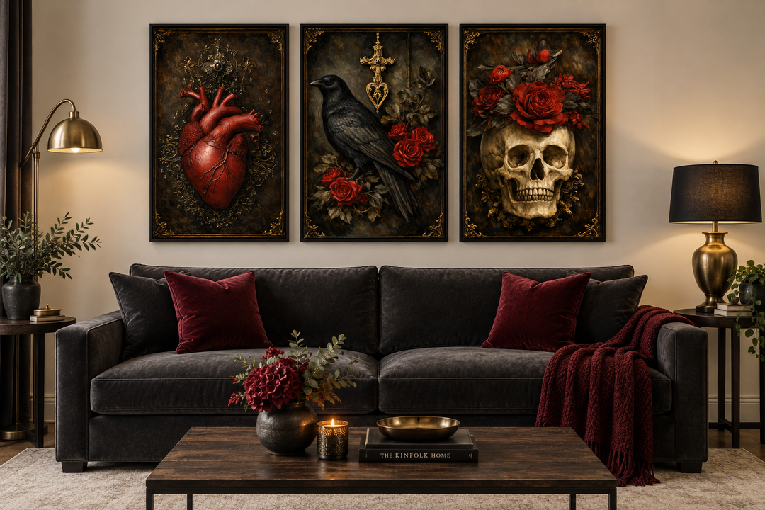 Gothic wall art set of 3 featuring a raven, skull, and anatomical heart above a dark velvet sofa.