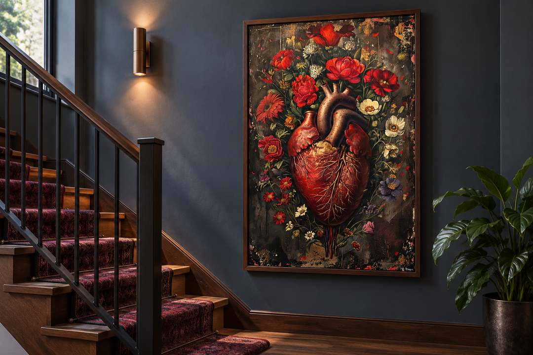 Gothic human heart and flowers framed wall art hanging on a dark wall next to a staircase.