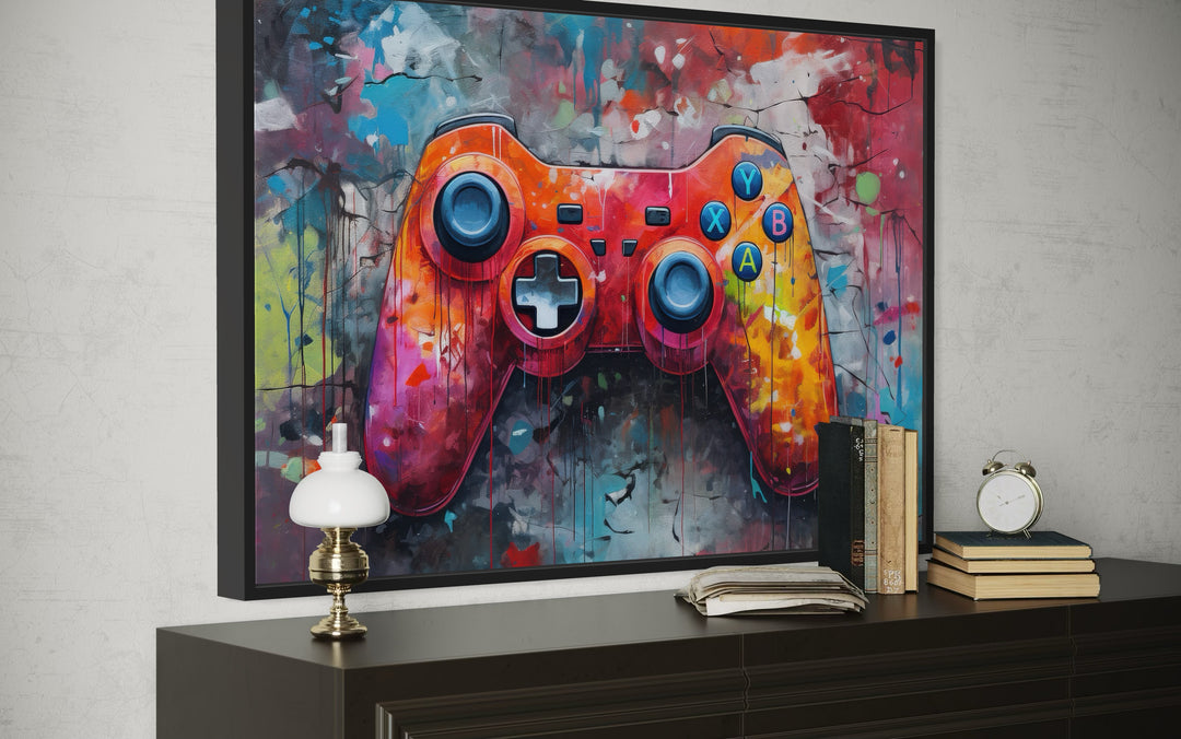 Framed canvas wall art featuring a vibrant graffiti-style painting of a game controller.