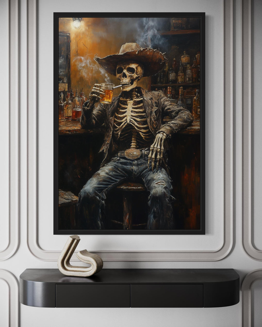 Framed wall art of a skeleton cowboy smoking and drinking in a dark Western saloon.