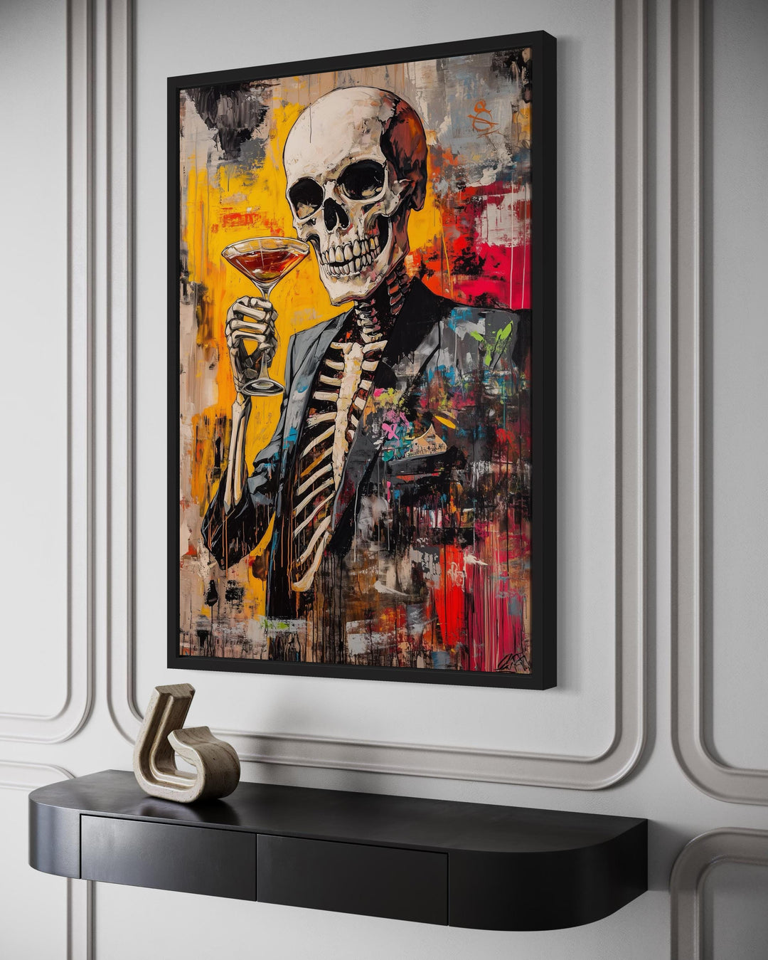 Graffiti skeleton in a suit holding a martini glass framed canvas art on a white paneled wall.