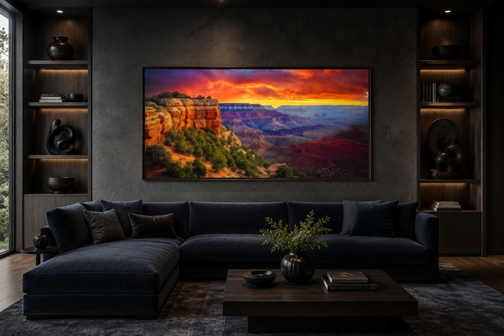 Framed Grand Canyon sunset canvas wall art above a navy blue sectional sofa in a modern living room.