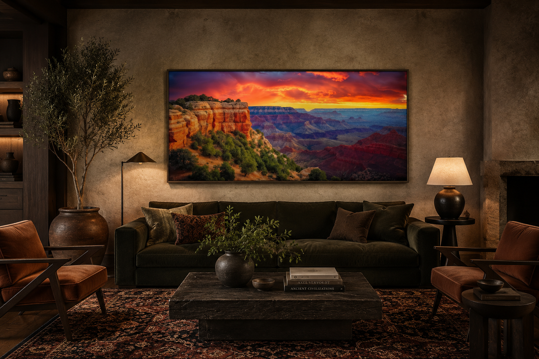 Framed Grand Canyon sunset canvas print with vibrant orange and red sky over a living room sofa.