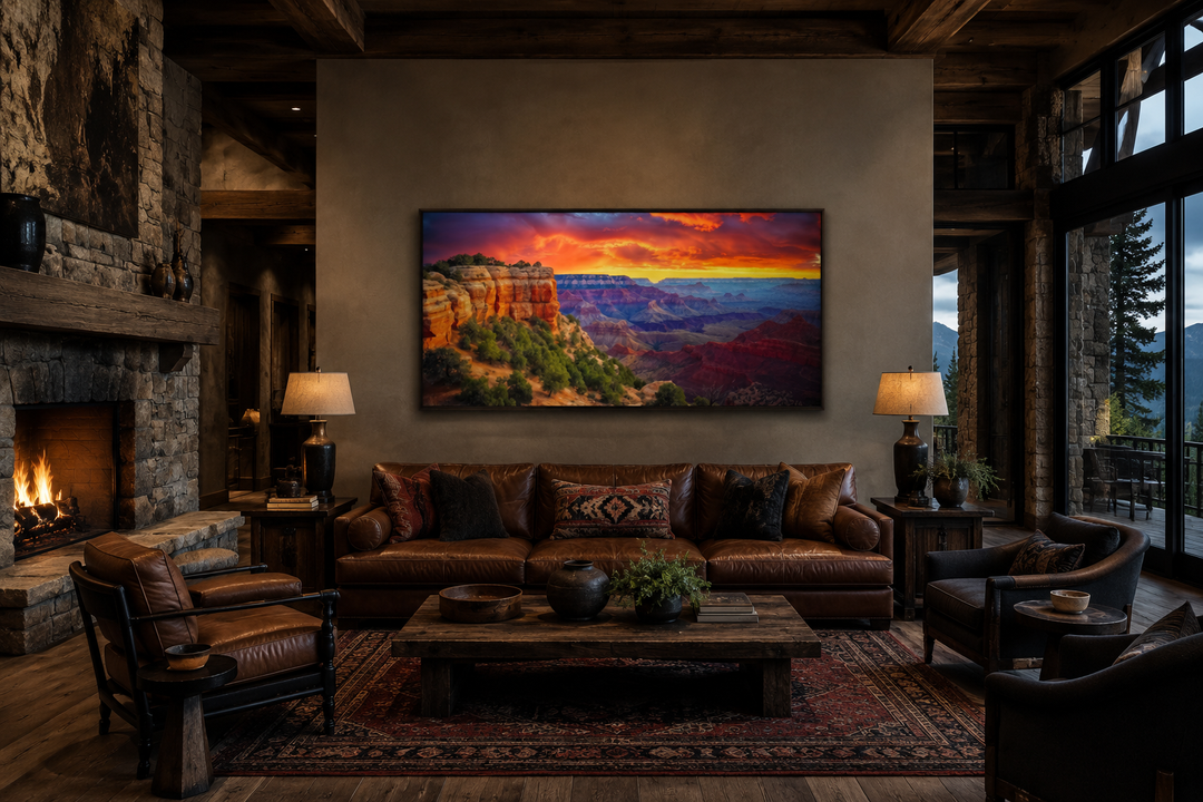 Framed panoramic canvas print of a vibrant Grand Canyon sunset hanging above a brown leather sofa.