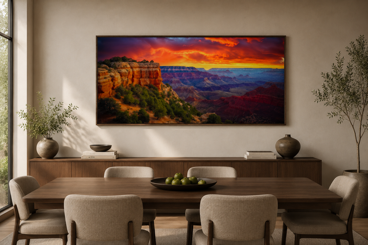 Framed Grand Canyon sunset canvas print hanging above a dining table in a modern room.
