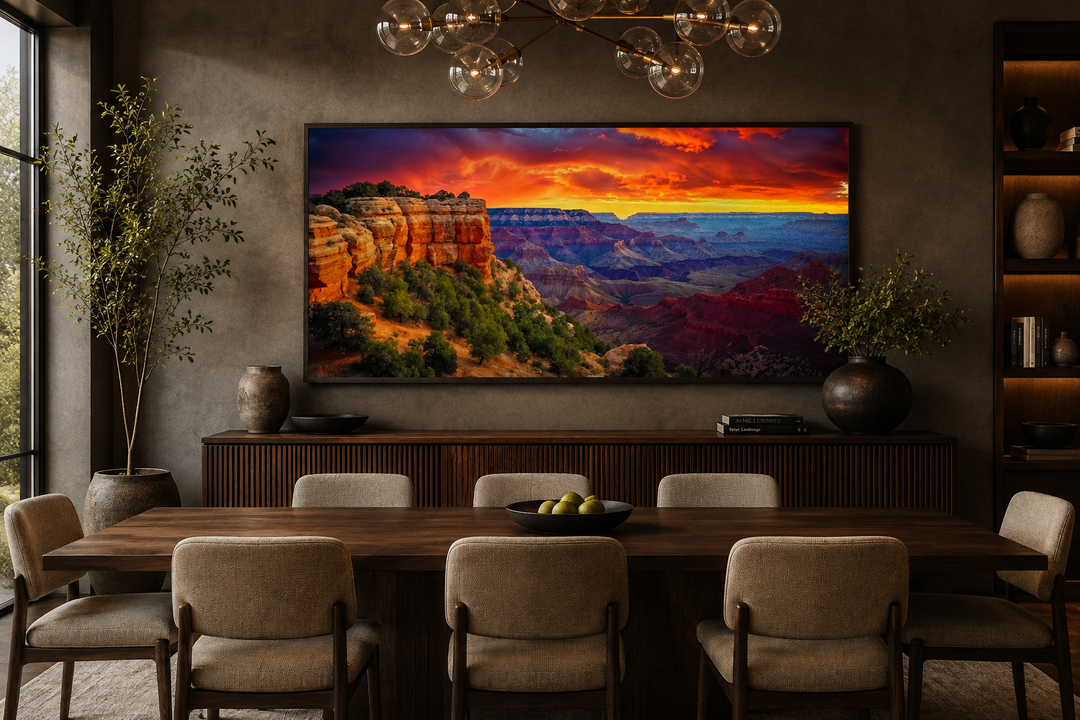 Framed panoramic canvas print of a Grand Canyon sunset over a dining table in a modern room.